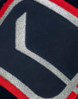 Close-up of a sports jersey with a logo on a navy background