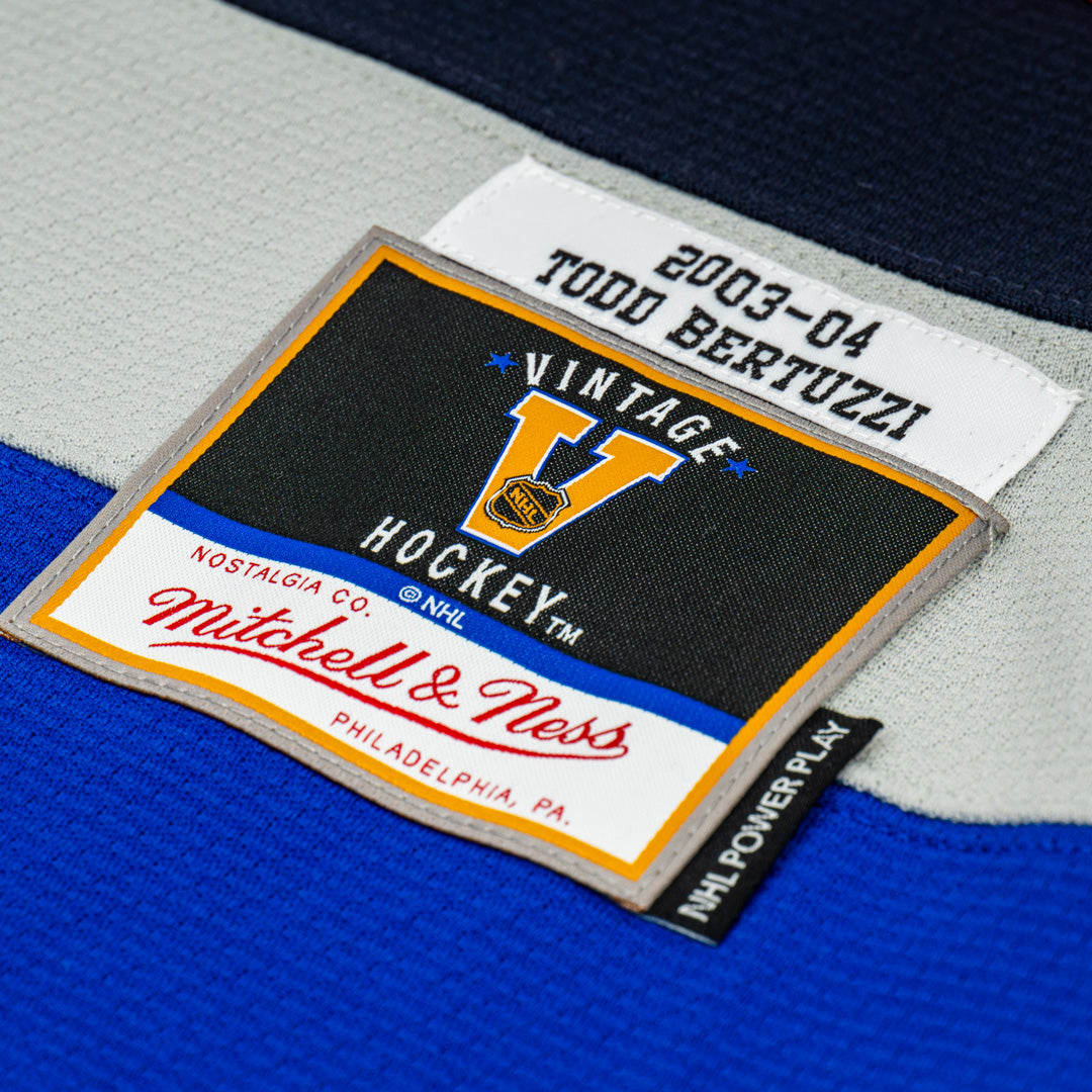 Close-up of a hockey jersey label with 'Vintage Hockey' and 'Mitchell & Ness' branding.